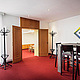 PST_Seminar_Events_Atelier_Pausenraum Vorraum und Pausenbereich eines Seminarraums mit Stehtischen, Sitzgelegenheiten und Zugang zum angrenzenden Veranstaltungsbereich.
