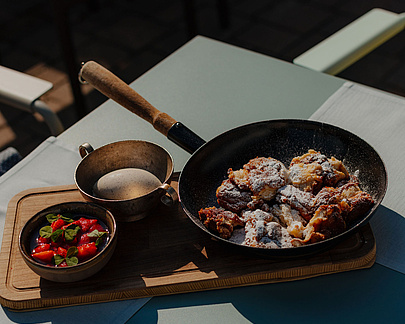 Kaiserschmarrn mit Erdbeeren und Vanilleeis serviert im Gastgarten